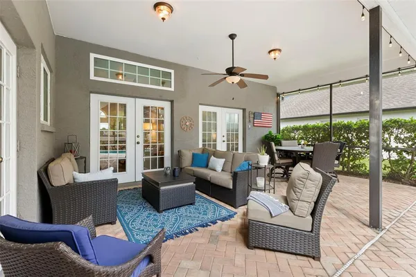 a living room with furniture ceiling fan and a window