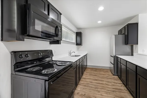 a kitchen with a stove and a microwave