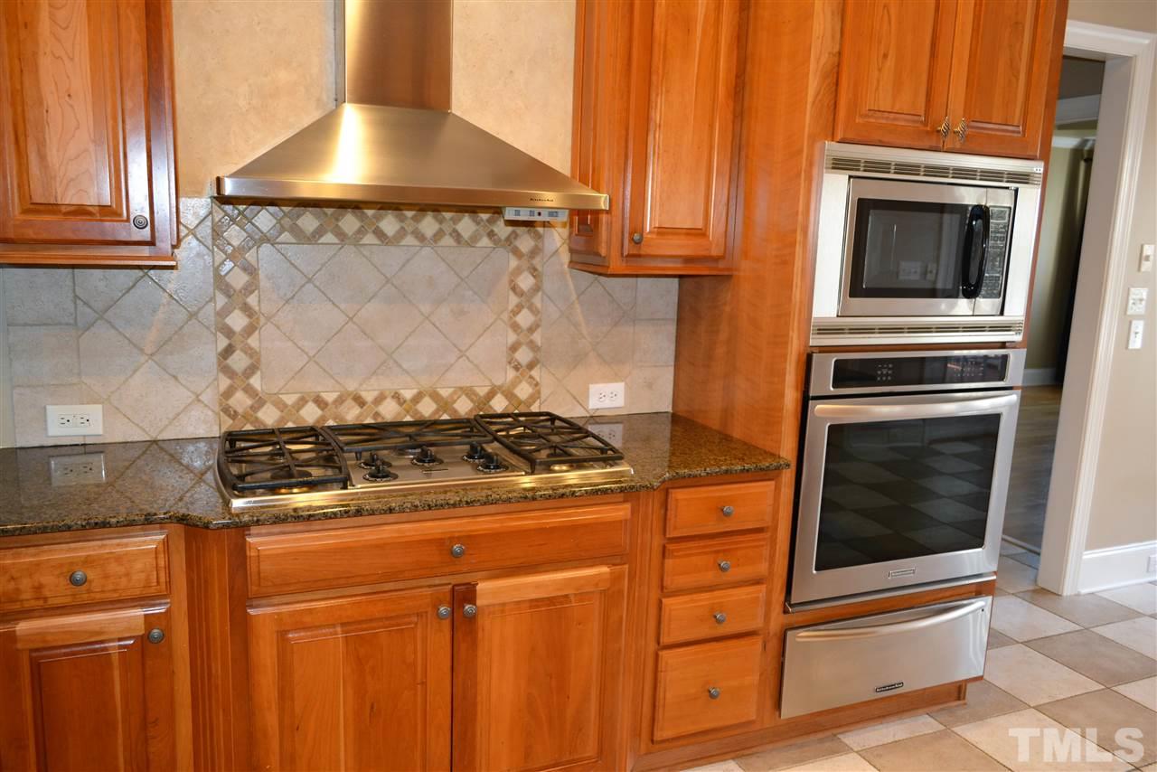 1316 Wynncrest Court Raleigh, NC 27603 - Photo 11 of 30 a stove top oven sitting inside of a kitchen