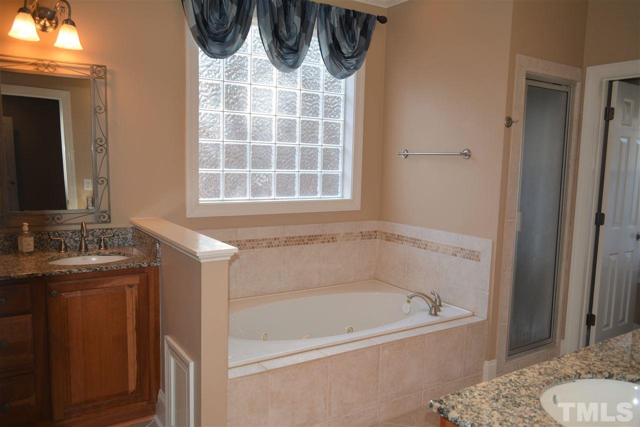 1316 Wynncrest Court Raleigh, NC 27603 - Photo 18 of 30 a bathroom with a bathtub and a shower