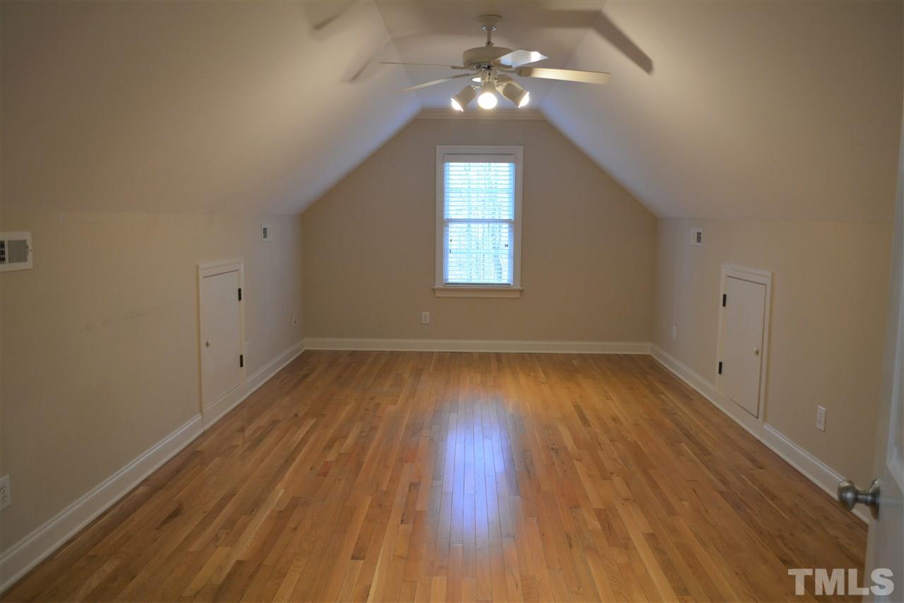 1316 Wynncrest Court Raleigh, NC 27603 - Photo 23 of 30 an empty room with wooden floor chandelier fan and windows