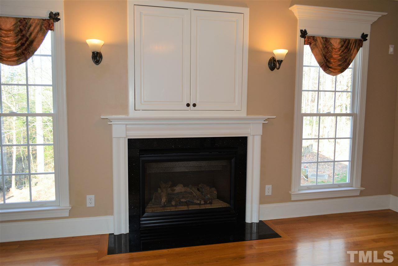 1316 Wynncrest Court Raleigh, NC 27603 - Photo 8 of 30 an empty room with windows and fireplace