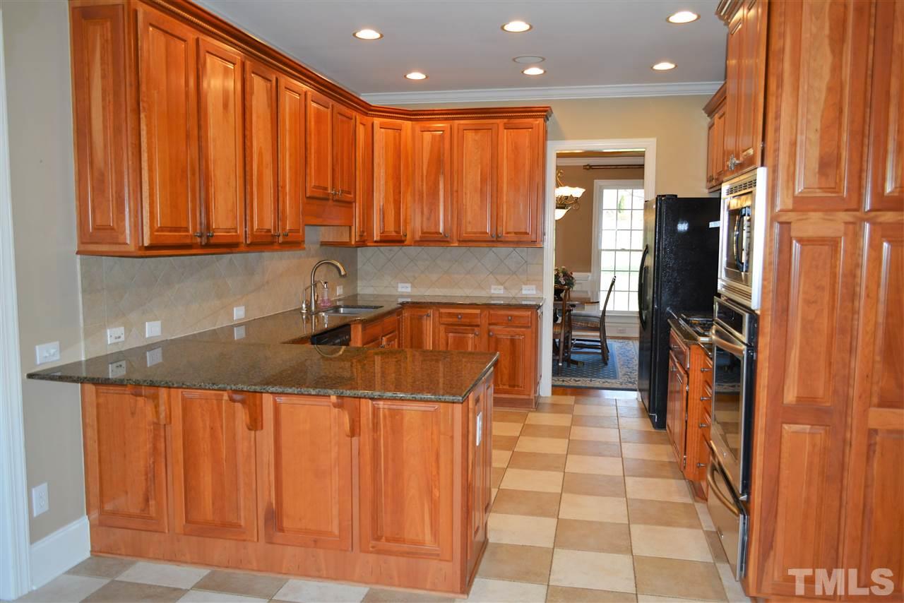 1316 Wynncrest Court Raleigh, NC 27603 - Photo 9 of 30 a kitchen with stainless steel appliances granite countertop a sink a stove and a refrigerator