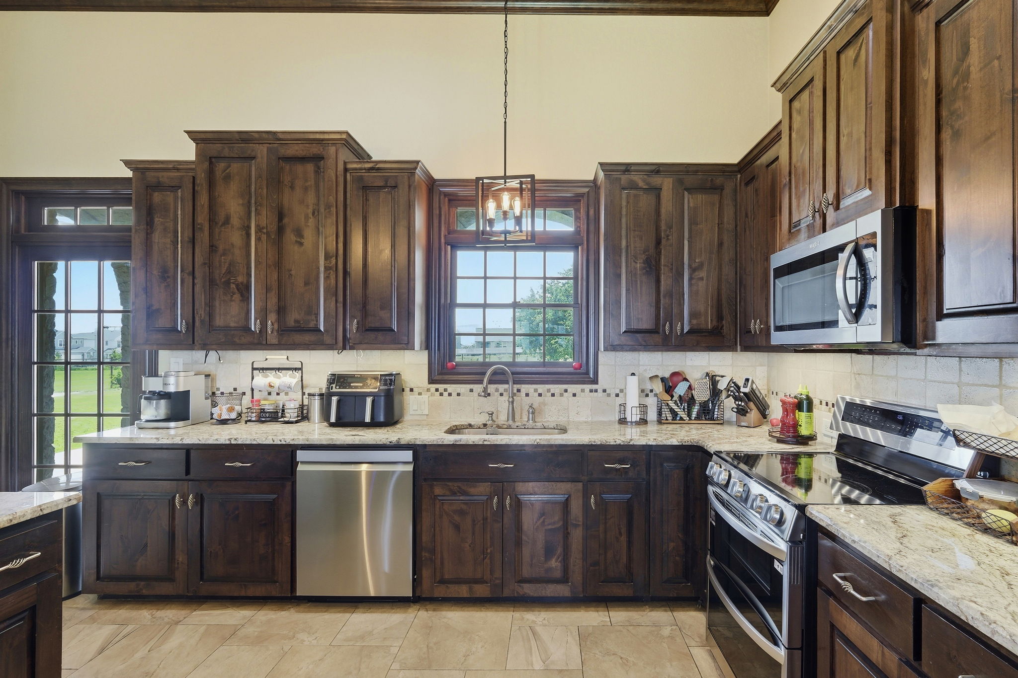 701 County Road 107 Georgetown, TX 78626 - Photo 14 of 30 a kitchen with stainless steel appliances granite countertop a sink stove and cabinets