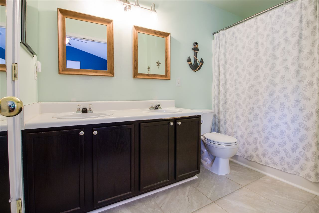 5022 Echo Ridge Road Raleigh, NC 27612 - Photo 15 of 22 a bathroom with a sink mirror and toilet