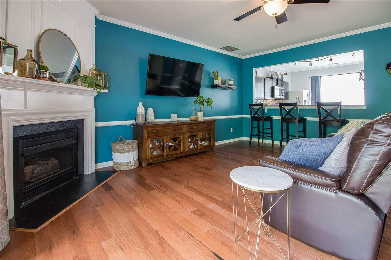 5022 Echo Ridge Road Raleigh, NC 27612 - Photo 9 of 22 a living room with furniture a flat screen tv and a fireplace