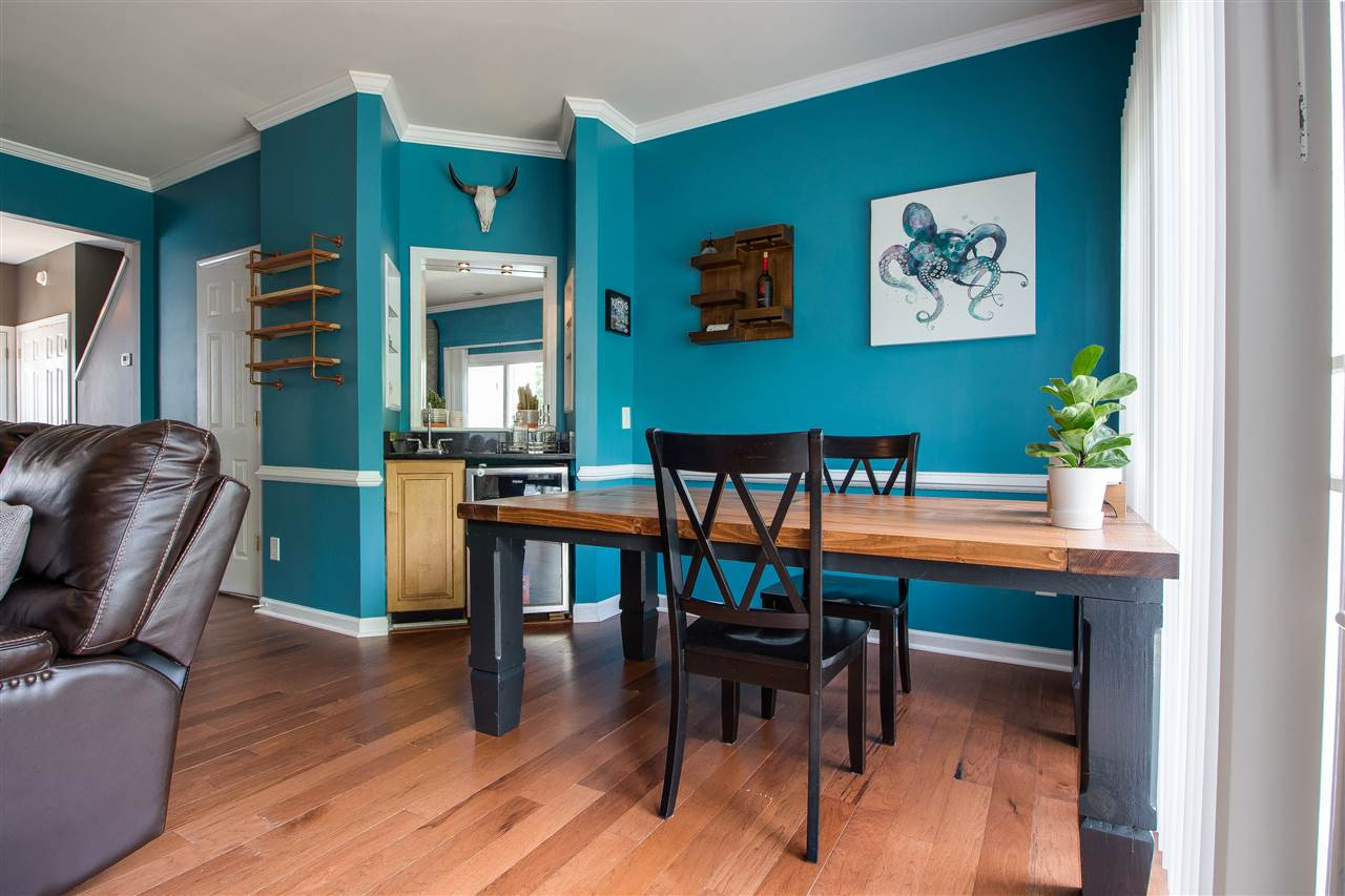 5022 Echo Ridge Road Raleigh, NC 27612 - Photo 10 of 22 a view of a dining room with furniture window and wooden floor