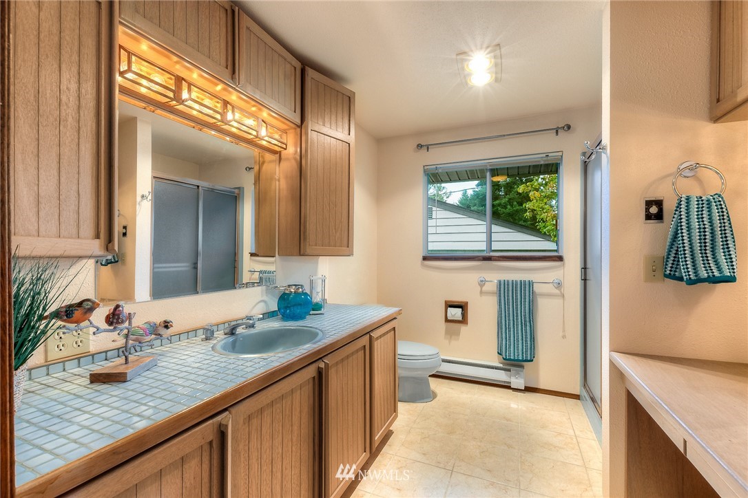 13453 Patriot Way Renton, WA 98059 - Photo 12 of 25 a bathroom with a granite countertop sink and a mirror