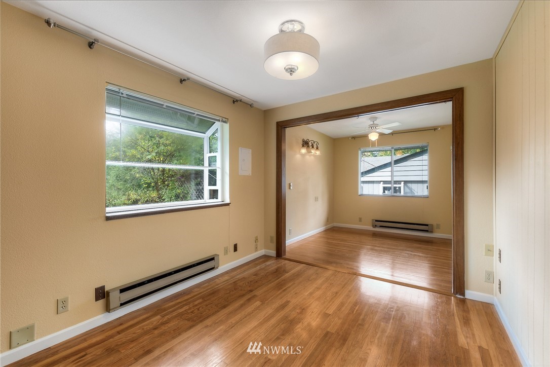 13453 Patriot Way Renton, WA 98059 - Photo 14 of 25 a view of an empty room with wooden floor and a window