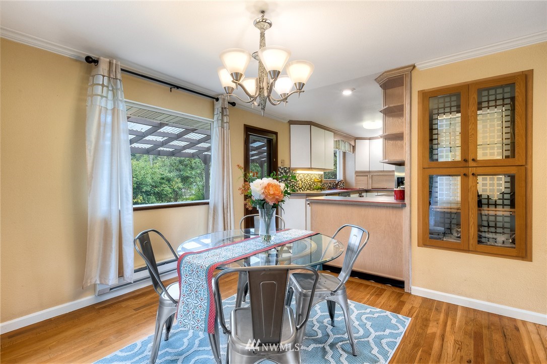 13453 Patriot Way Renton, WA 98059 - Photo 6 of 25 a dining room with furniture a large window and wooden floor