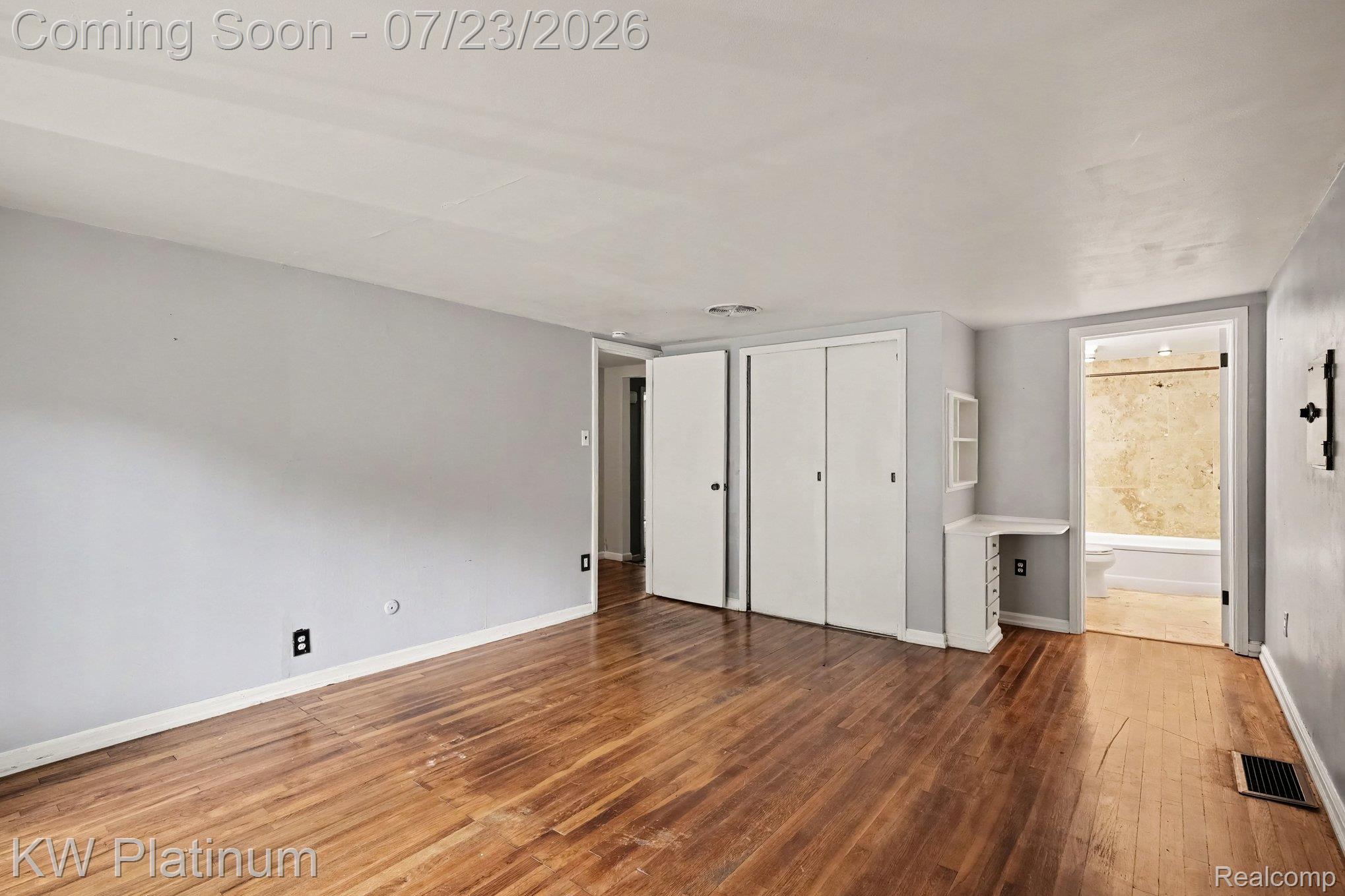 4885 Lakeshore Road Fort Gratiot, MI 48059 - Photo 8 of 26 Spacious room featuring wood-finish flooring, light gray walls, and white trim