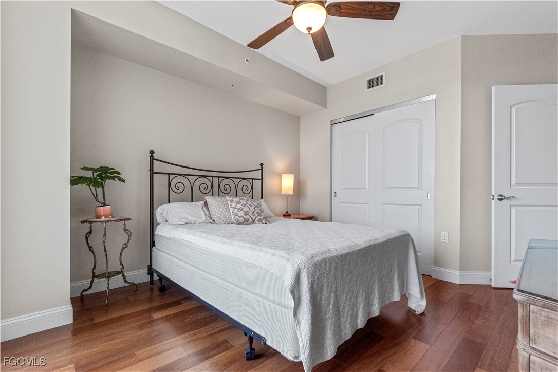 2090 West First Street, Unit I409 Fort Myers, FL 33901 - Photo 13 of 44 a bedroom with a bed and wooden floor