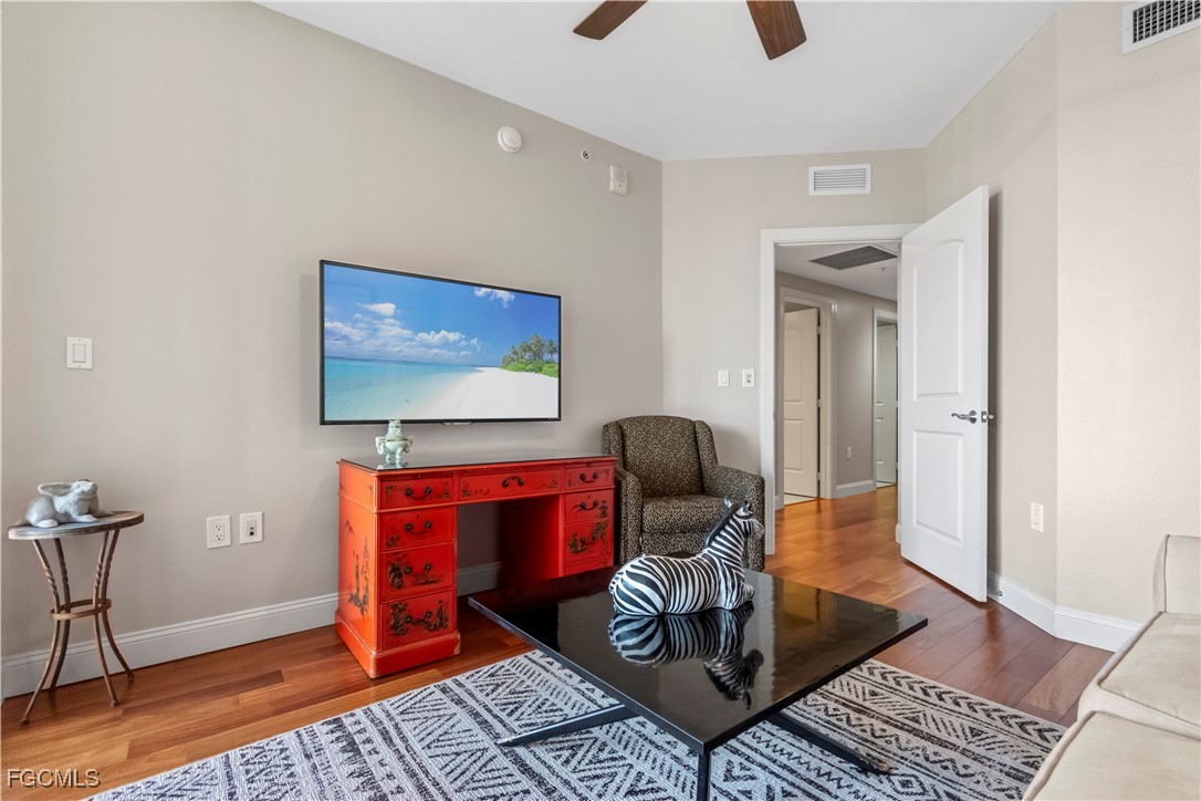 2090 West First Street, Unit I409 Fort Myers, FL 33901 - Photo 15 of 44 a living room with furniture and a flat screen tv