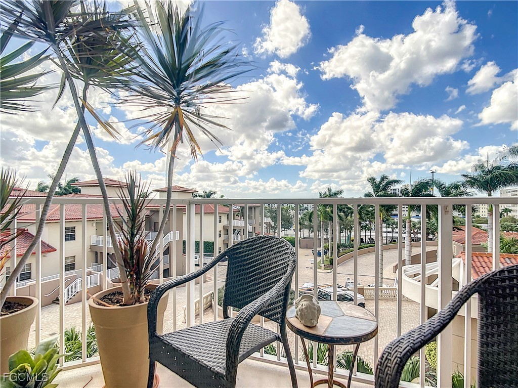 2090 West First Street, Unit I409 Fort Myers, FL 33901 - Photo 18 of 44 a balcony with table and chairs