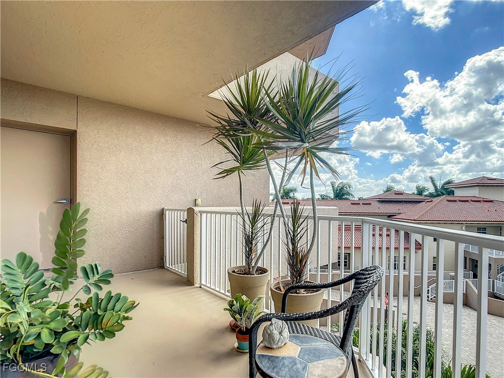 2090 West First Street, Unit I409 Fort Myers, FL 33901 - Photo 19 of 44 a view of a chair and table in patio with potted plants