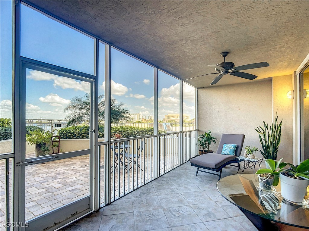 2090 West First Street, Unit I409 Fort Myers, FL 33901 - Photo 21 of 44 a living room with furniture and a floor to ceiling window