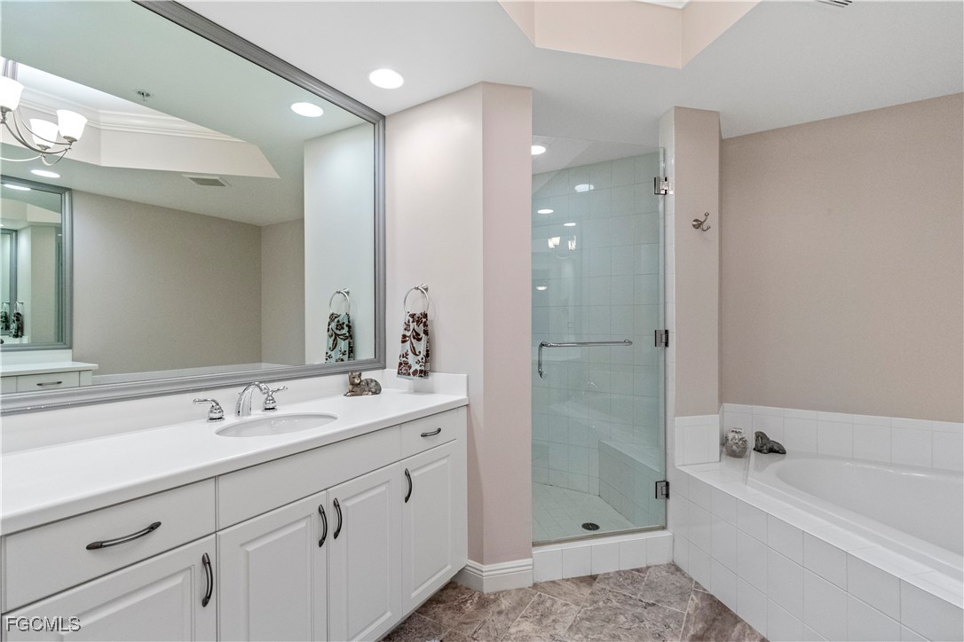 2090 West First Street, Unit I409 Fort Myers, FL 33901 - Photo 10 of 44 a bathroom with a double vanity sink mirror bathtub and shower