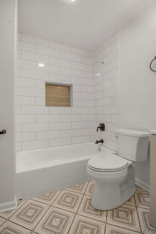 a bathroom with a toilet and a bathtub