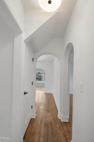 a view of a hallway with wooden floor
