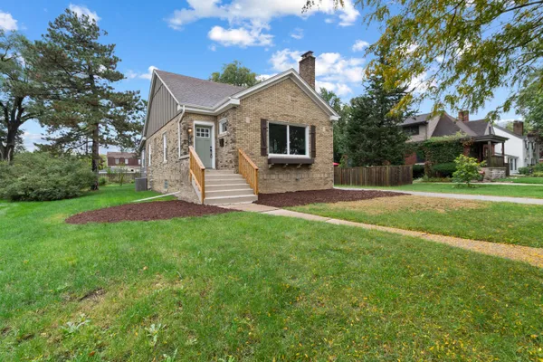 a front view of house with yard and green space