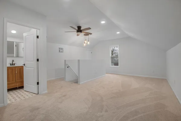 an empty room with a bathroom and a shower