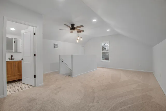 an empty room with a bathroom and a shower