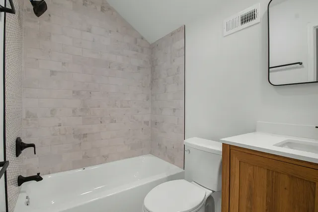 a bathroom with a sink toilet and bathtub
