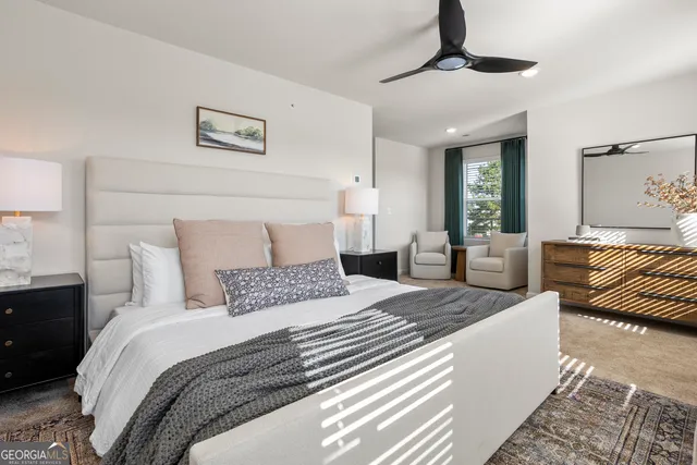 a bedroom with a large bed and a couch