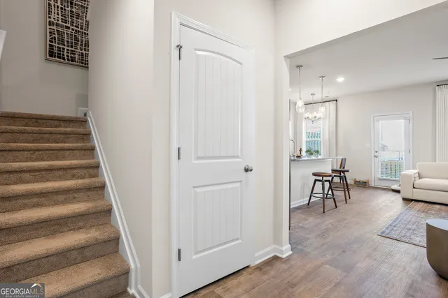 a view of a livingroom with furniture and stairs