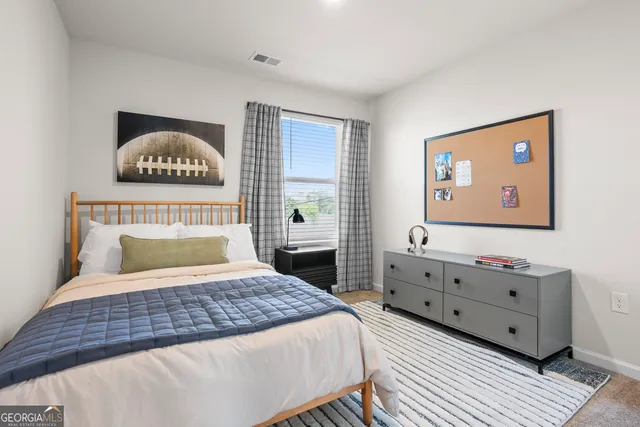 a bedroom with a bed and a dresser