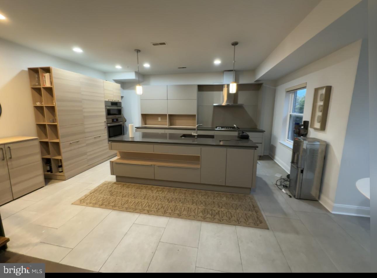 819 Cameron Street, Unit 1 Philadelphia, PA 19130 - Photo 1 of 22 a kitchen with stainless steel appliances kitchen island granite countertop a sink and cabinets