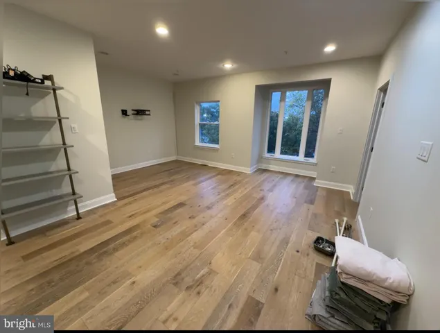 a view of room with window and wooden floor