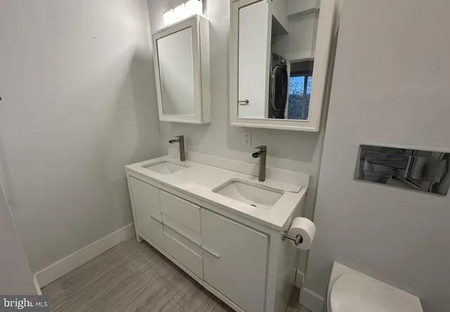 a utility room with sink dryer and washer