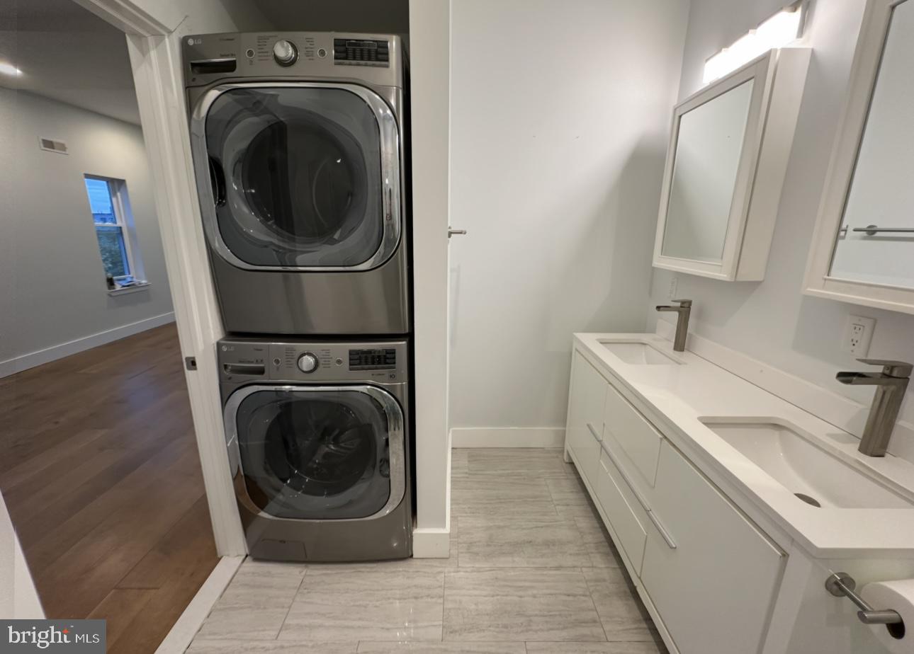 819 Cameron Street, Unit 1 Philadelphia, PA 19130 - Photo 14 of 22 a utility room with sink dryer and washer