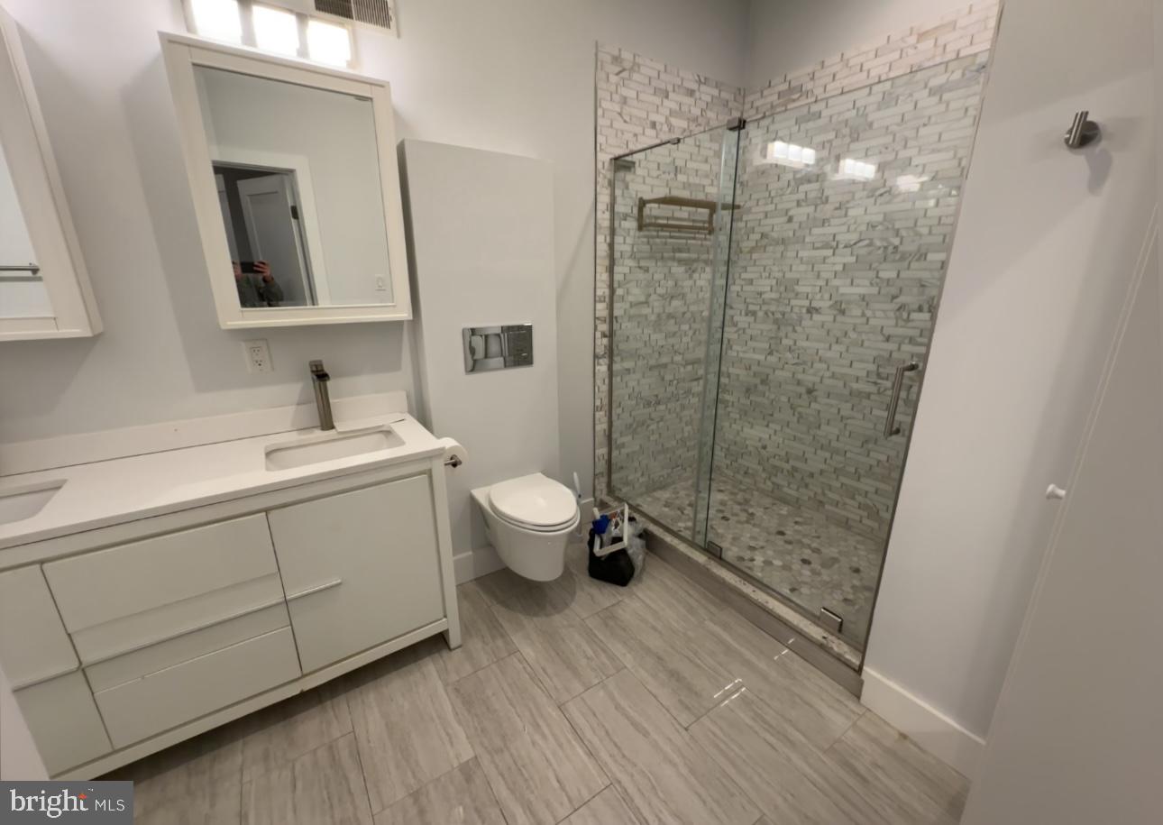 819 Cameron Street, Unit 1 Philadelphia, PA 19130 - Photo 15 of 22 a bathroom with a sink a toilet and shower