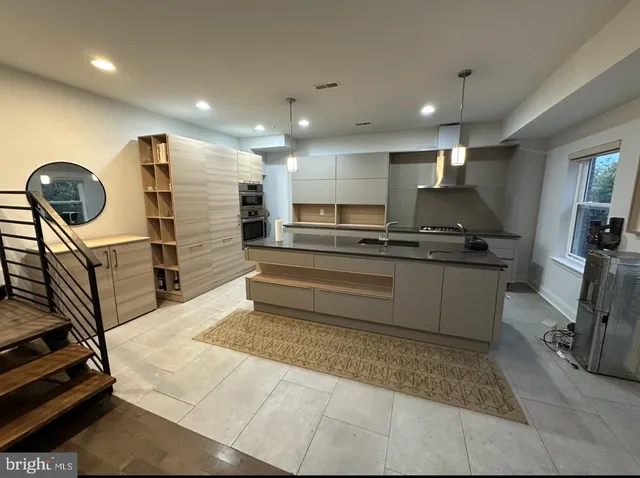 a kitchen with stainless steel appliances granite countertop a sink stove and cabinets