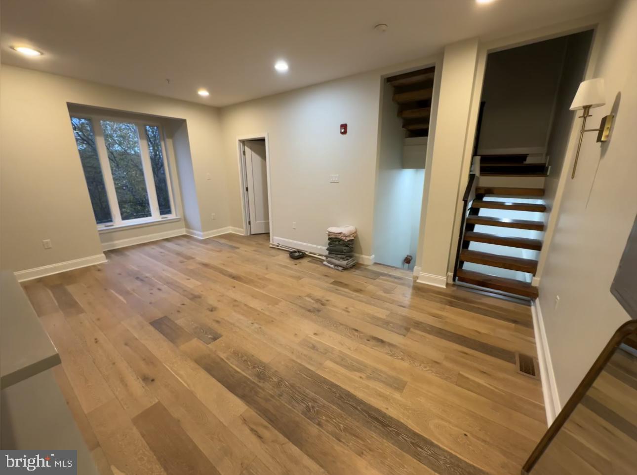 819 Cameron Street, Unit 1 Philadelphia, PA 19130 - Photo 6 of 22 a view of an empty room with wooden floor and stairs