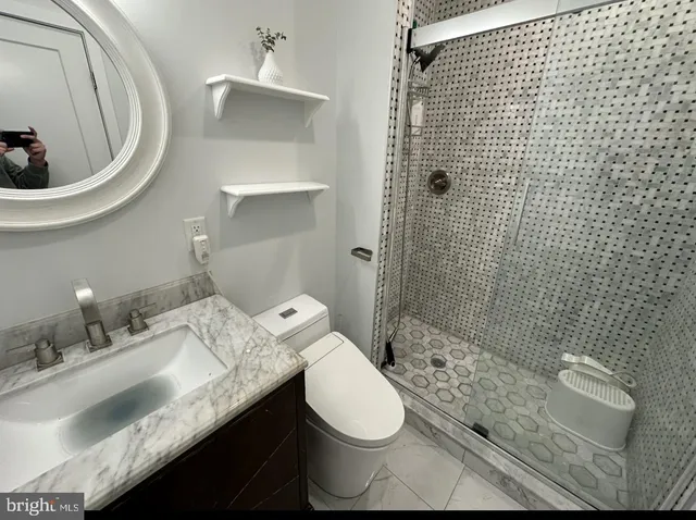 a bathroom with a sink toilet and shower