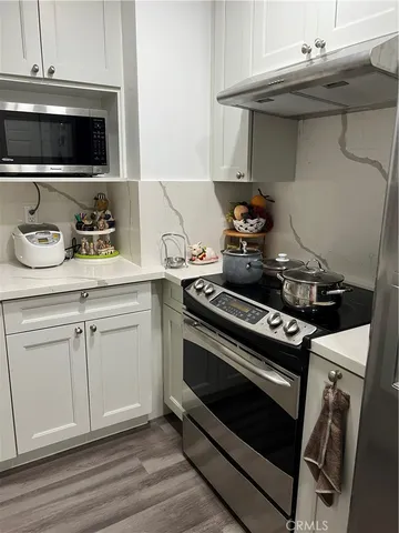 a large bed sitting in a bedroom next to a window