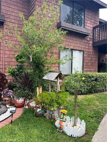 a front view of a house with a garden and plants