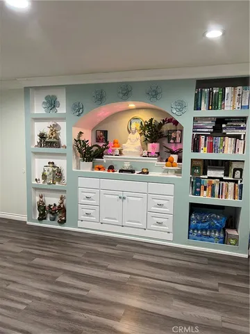 a living room with furniture and a book shelf