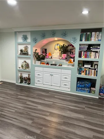 a view of a room with furniture and wooden floor