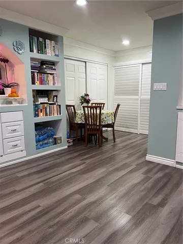 a view of a livingroom with a flat screen tv wooden floor and staircase