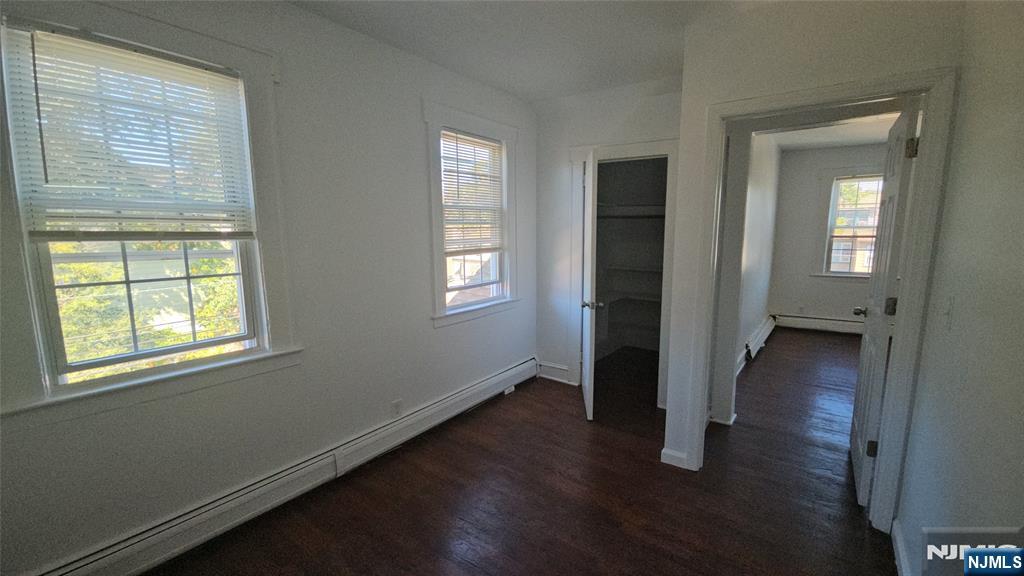 264-266 Pomona Avenue, Unit 3 Newark, NJ 07112 - Photo 12 of 27 an empty room with wooden floor and windows