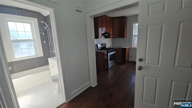 an empty room with wooden floor and a window