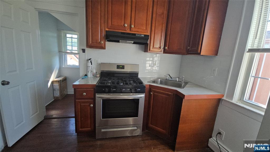 264-266 Pomona Avenue, Unit 3 Newark, NJ 07112 - Photo 20 of 27 a kitchen with stainless steel appliances granite countertop a stove a microwave and a refrigerator