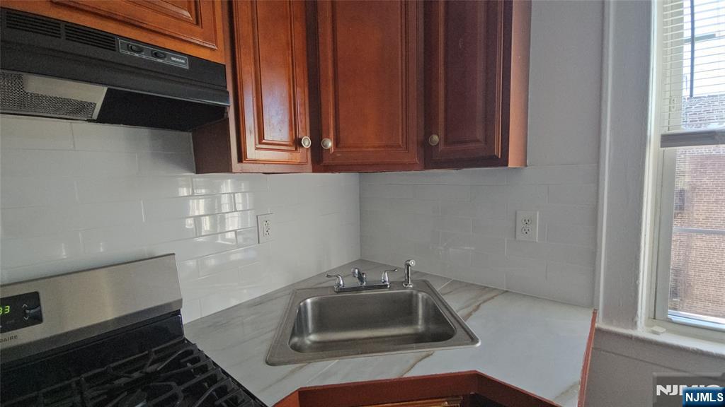 264-266 Pomona Avenue, Unit 3 Newark, NJ 07112 - Photo 21 of 27 a kitchen with a sink and cabinets
