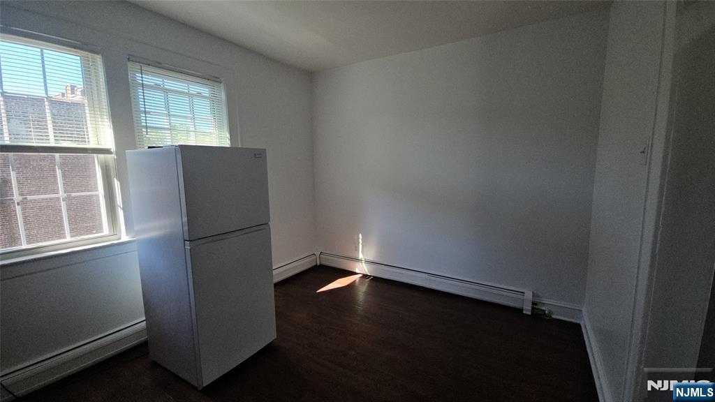 264-266 Pomona Avenue, Unit 3 Newark, NJ 07112 - Photo 22 of 27 an empty room with wooden floor and windows