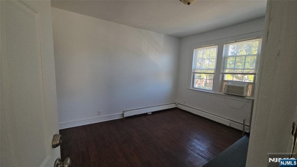 264-266 Pomona Avenue, Unit 3 Newark, NJ 07112 - Photo 6 of 27 an empty room with wooden floor and windows