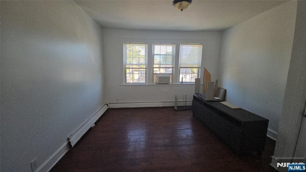 264-266 Pomona Avenue, Unit 3 Newark, NJ 07112 - Photo 7 of 27 an empty room with wooden floor and windows